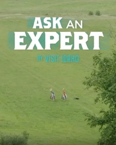 Two people on horseback far off in a field with "ask and expert" above them