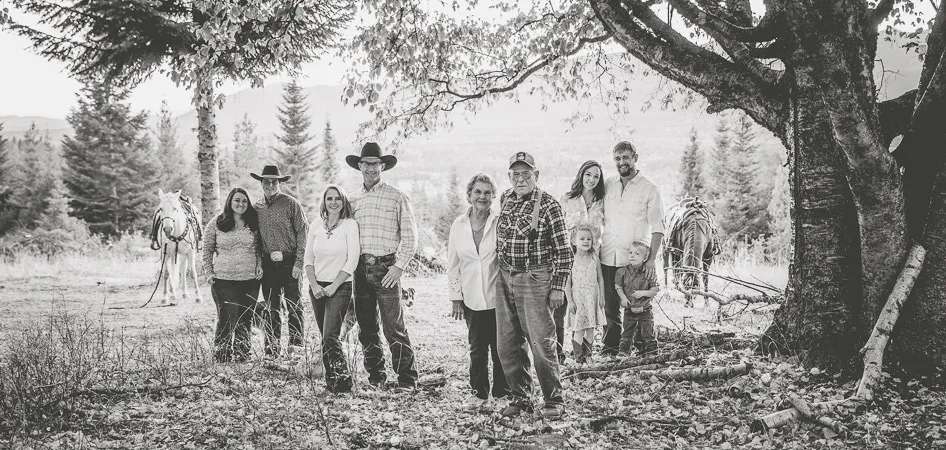 Western Pleasure Guest Ranch Family Photo in black and white family stands together under a tree