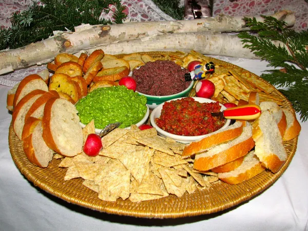 A platter of bread, chips and dips
