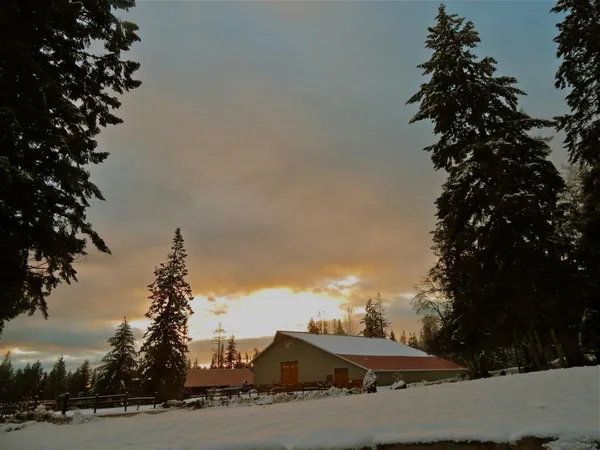 The indoor arena at sunset in the snow