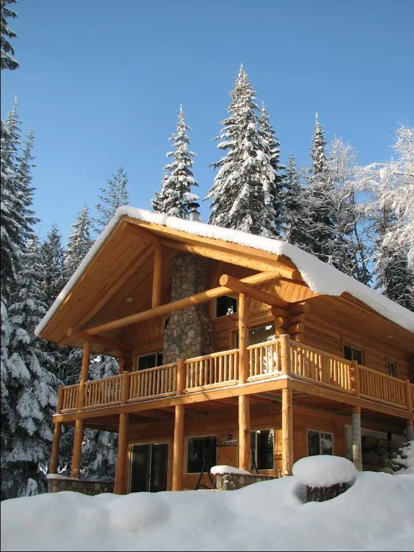 Meadow View cabin under snow against a blue sky