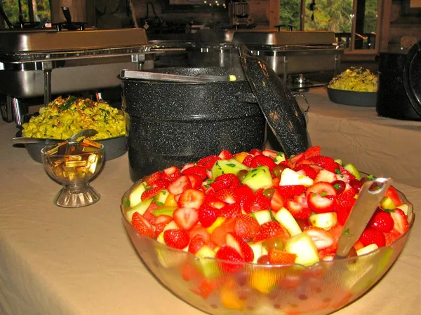 A bowl of fruit salad on the buffet line
