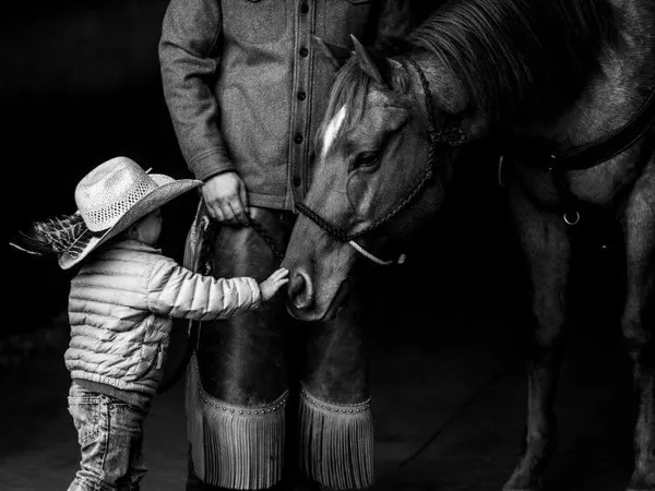black and white photo of little boy and horse