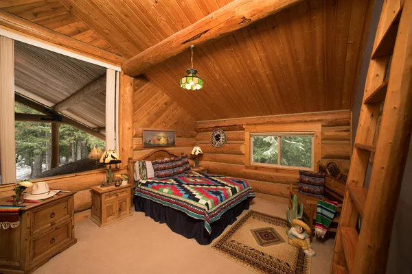 Southwestern style room with log walls rustic wood furniture