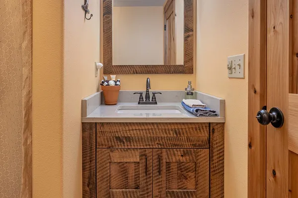 Rustic wood vanity and mirror in the Siesta room's bathroom