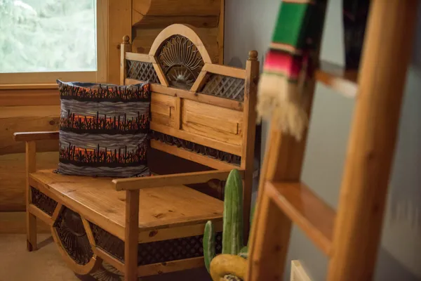 Southwest styled wood bench with cactus pillow in lodge room