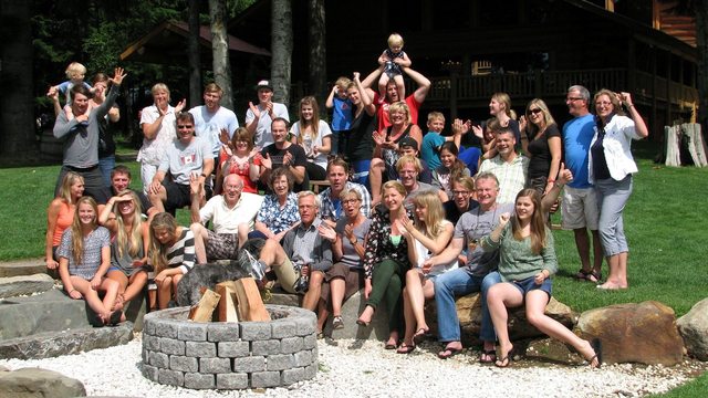 Large Family Reunion group standing behind a fire pit