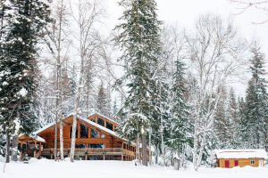 Log lodge and log cabins at Idaho dude ranch in a snow covered forest
