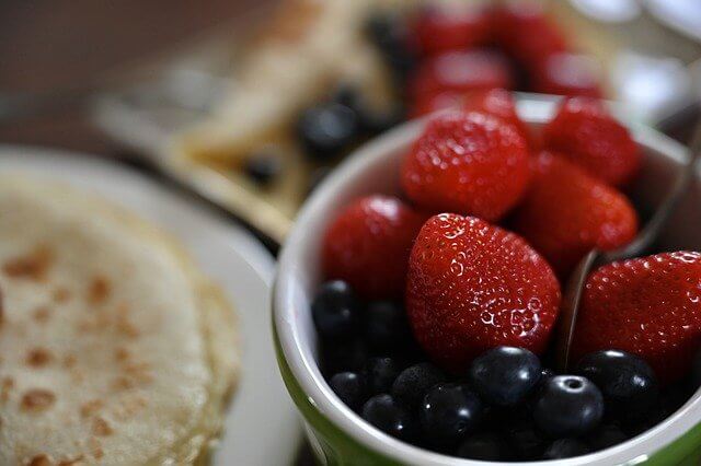 bowl of berries with pancakes